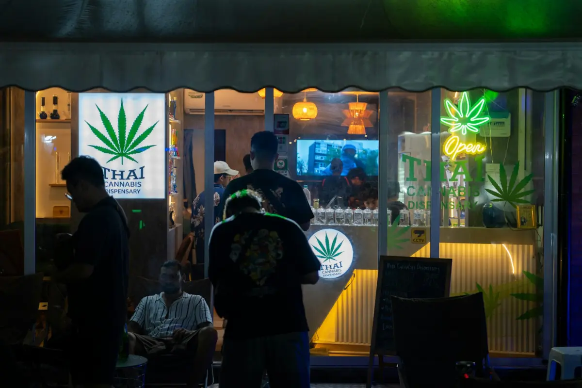 A group of people standing outside of a store