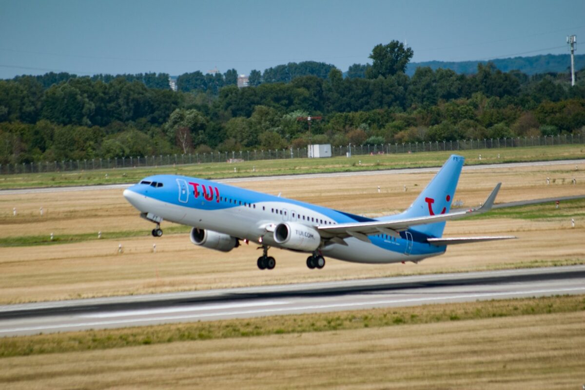 white and blue passenger plane on airport during daytime