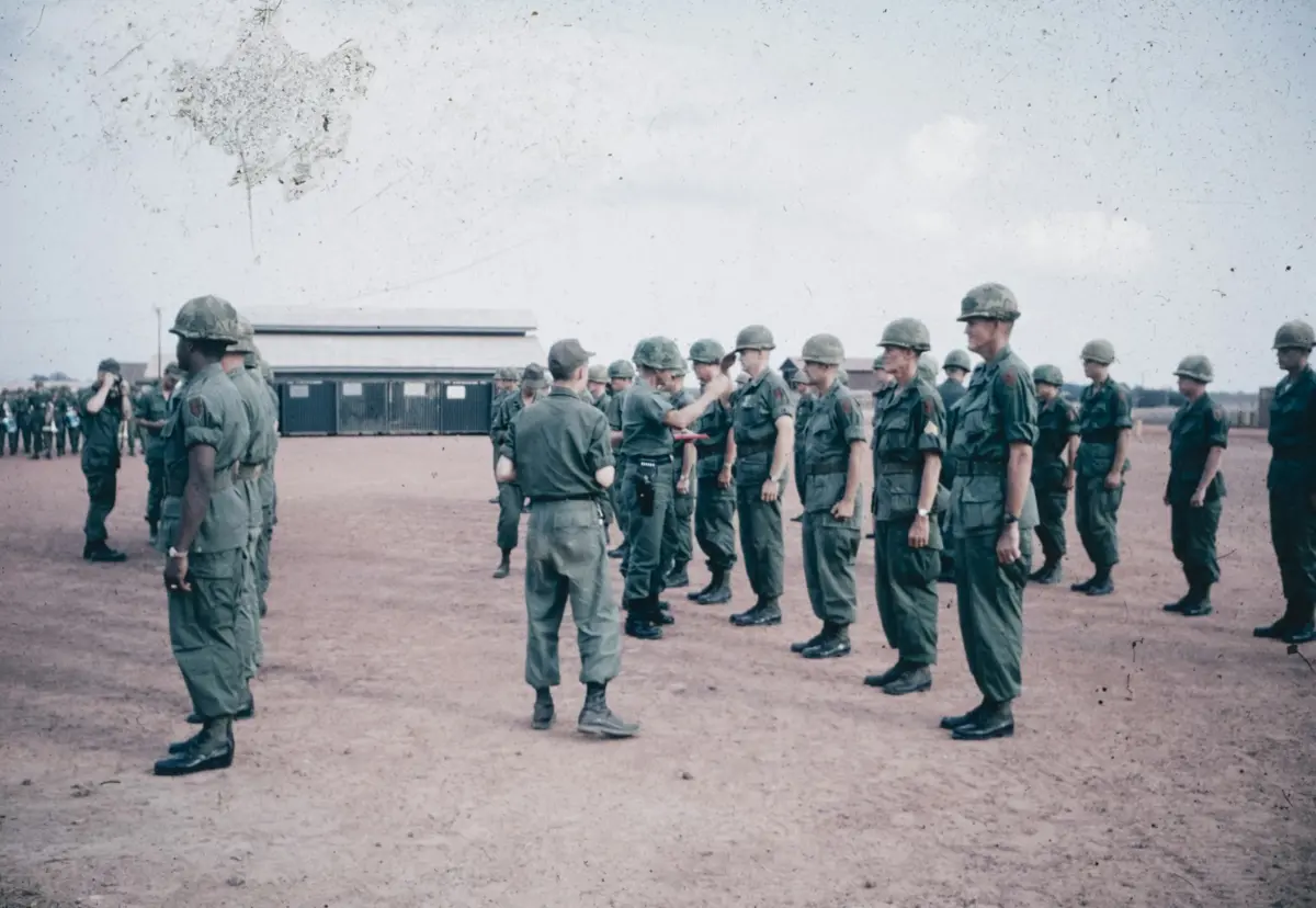 A group of men in military uniforms standing in a circle