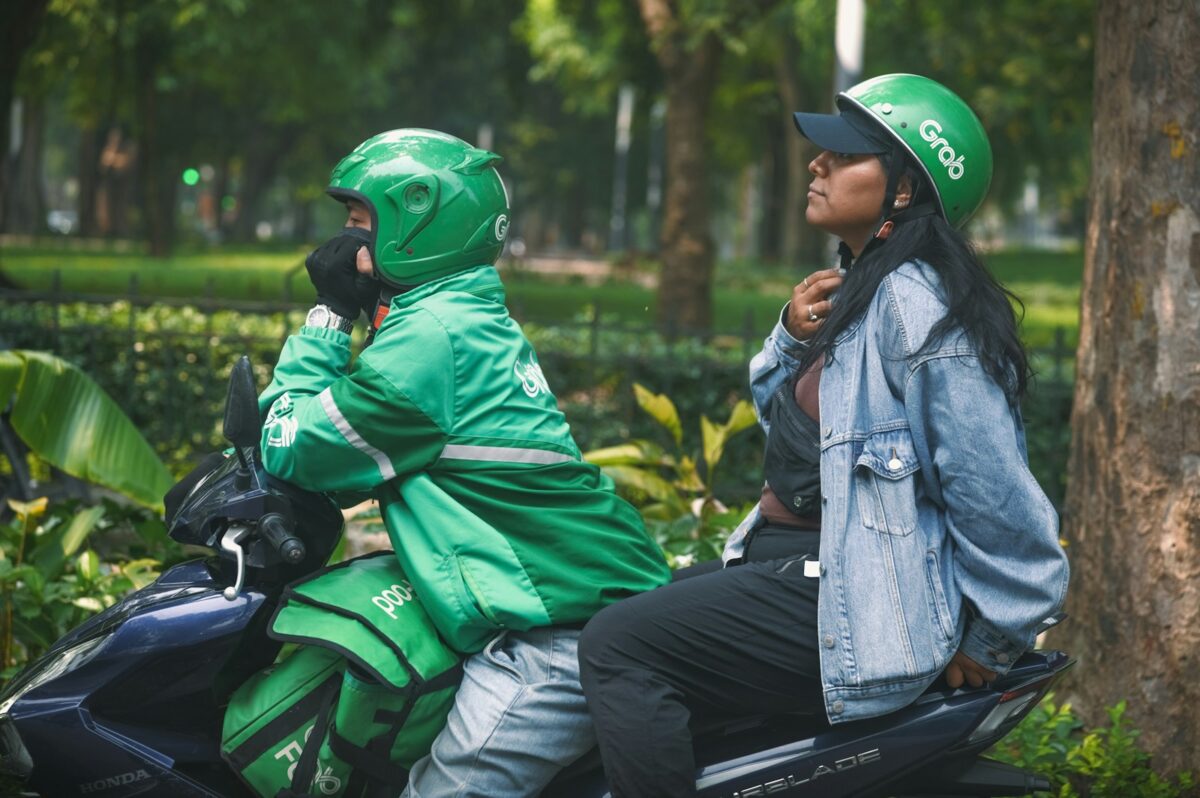 A man and a woman sitting on a motorcycle
