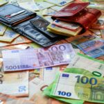 a pile of money sitting on top of a table