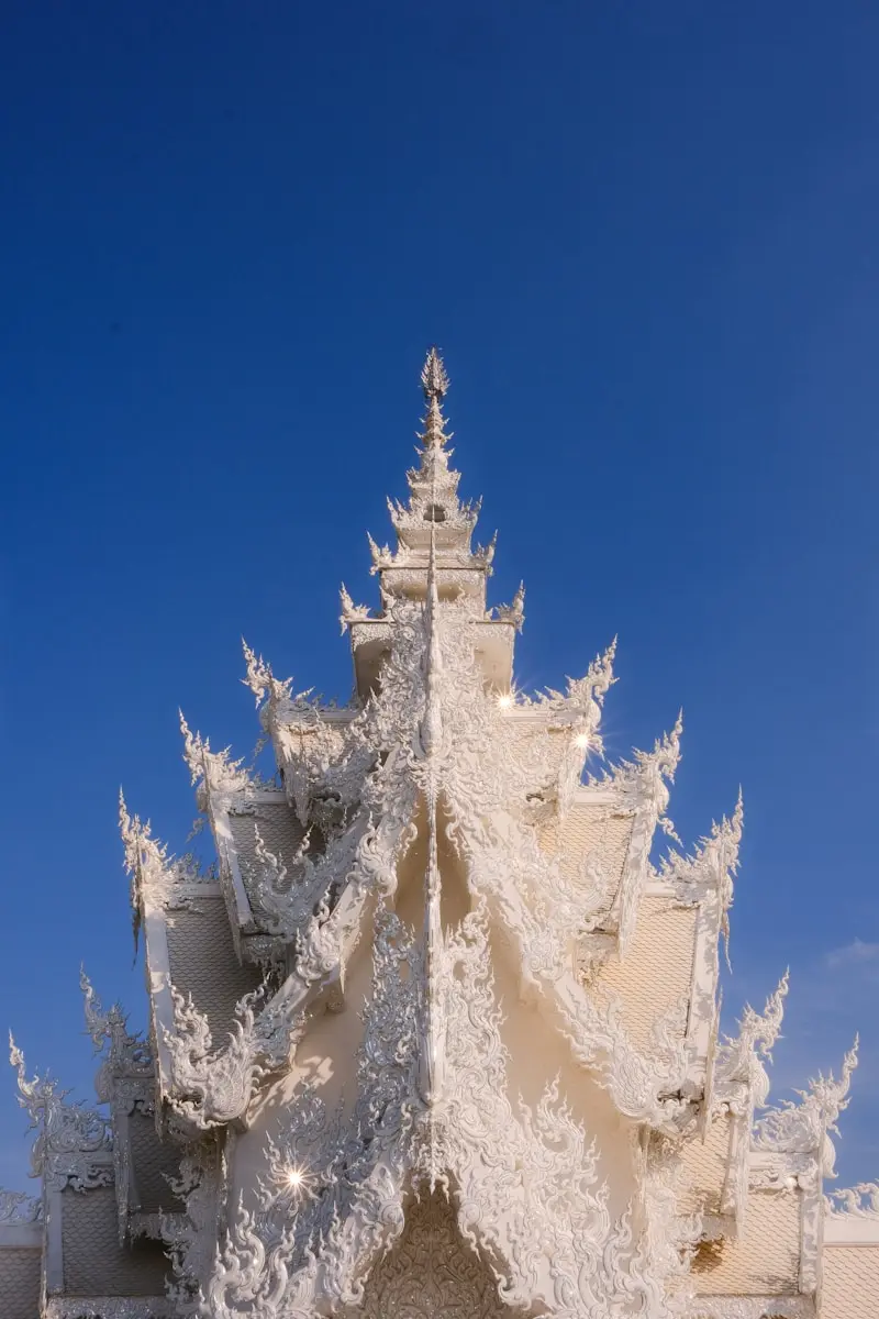 A large white building with a blue sky in the background