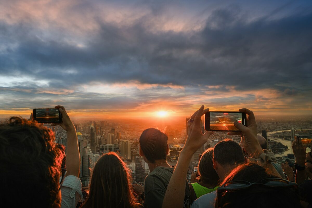 A group of people standing on top of a tall building