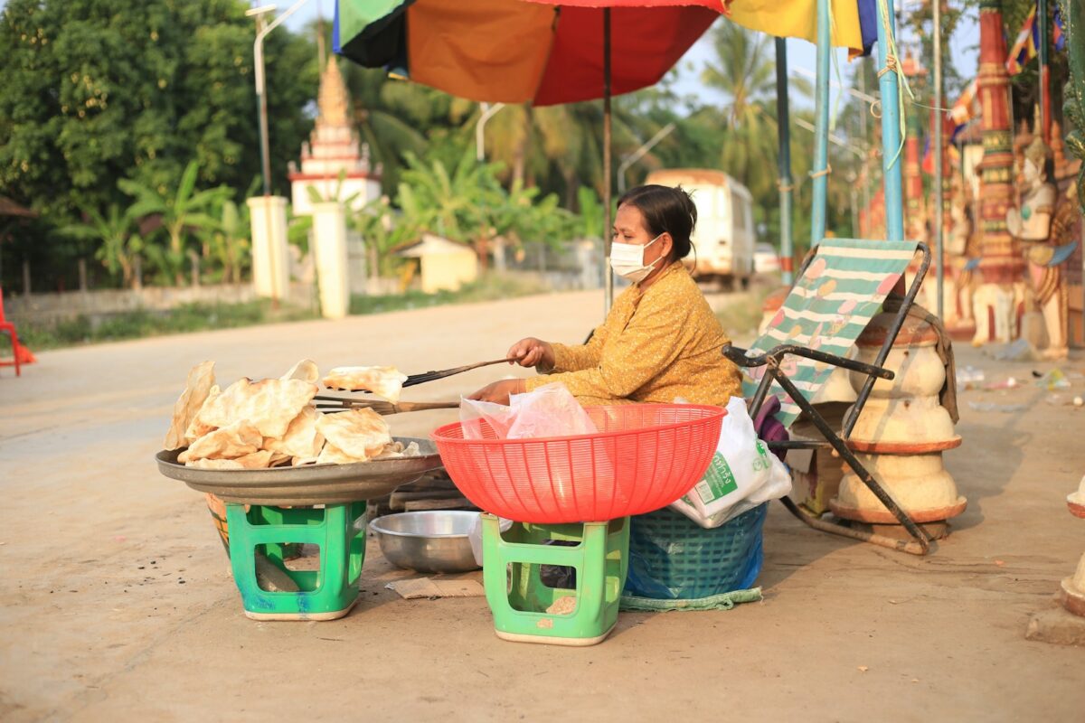 a woman sitting at a table with food on it